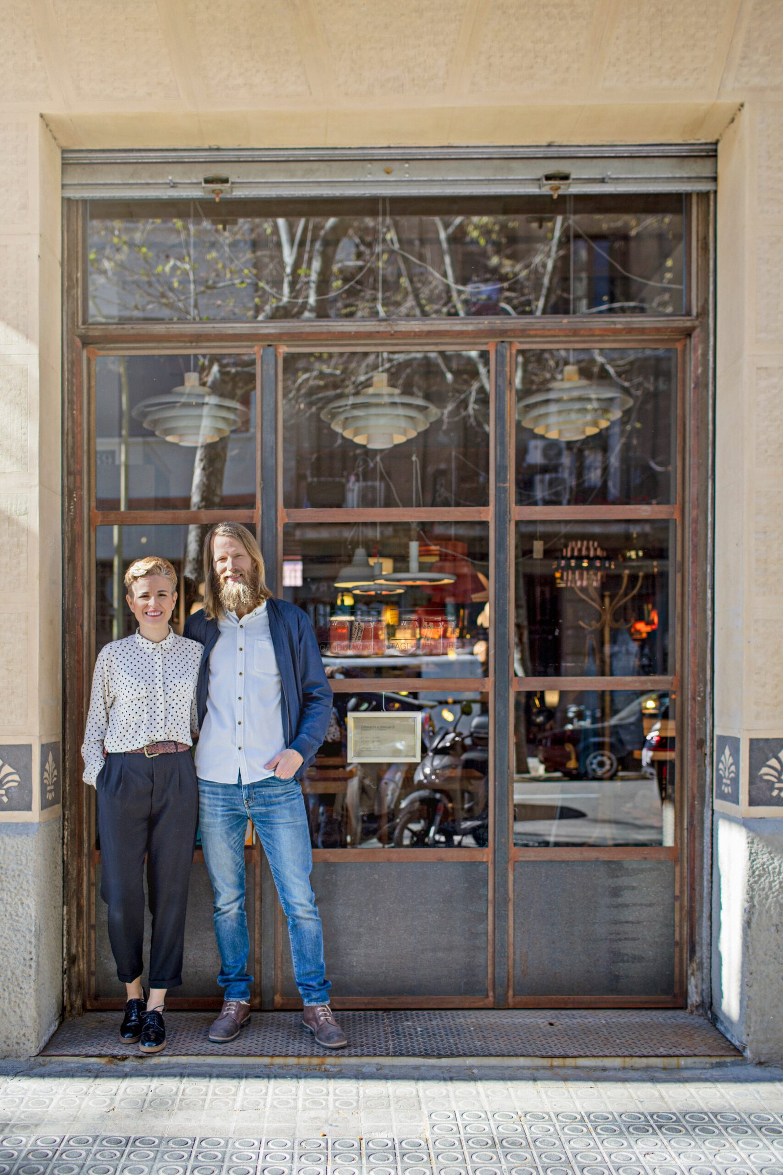 Small business owners standing at their storefront
